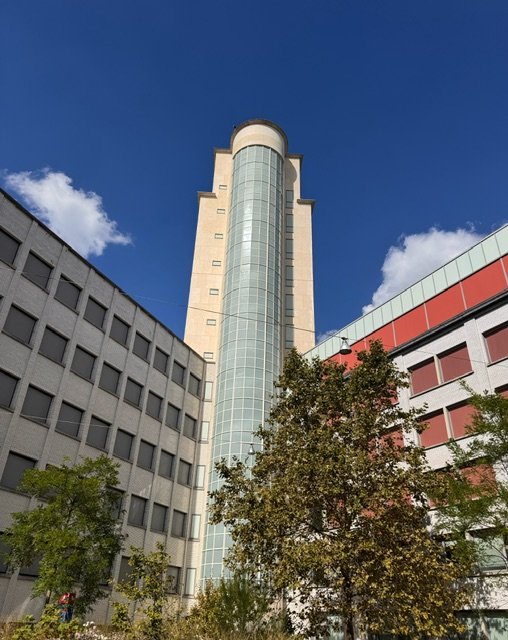 Een opvallende toren, overblijfsel tussen de nieuwe gebouwen.